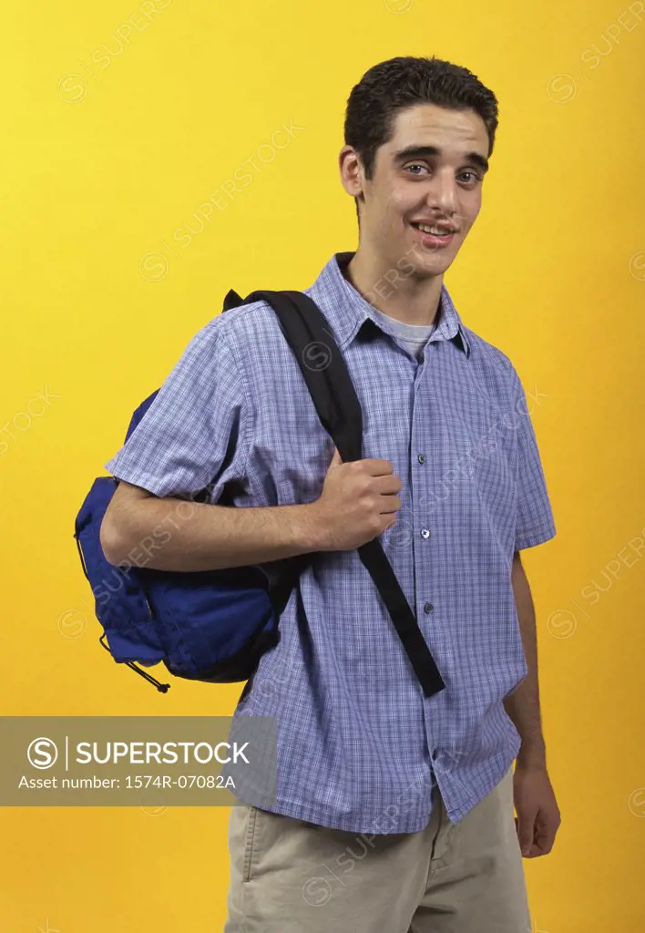 Portrait of a teenage boy carrying a backpack