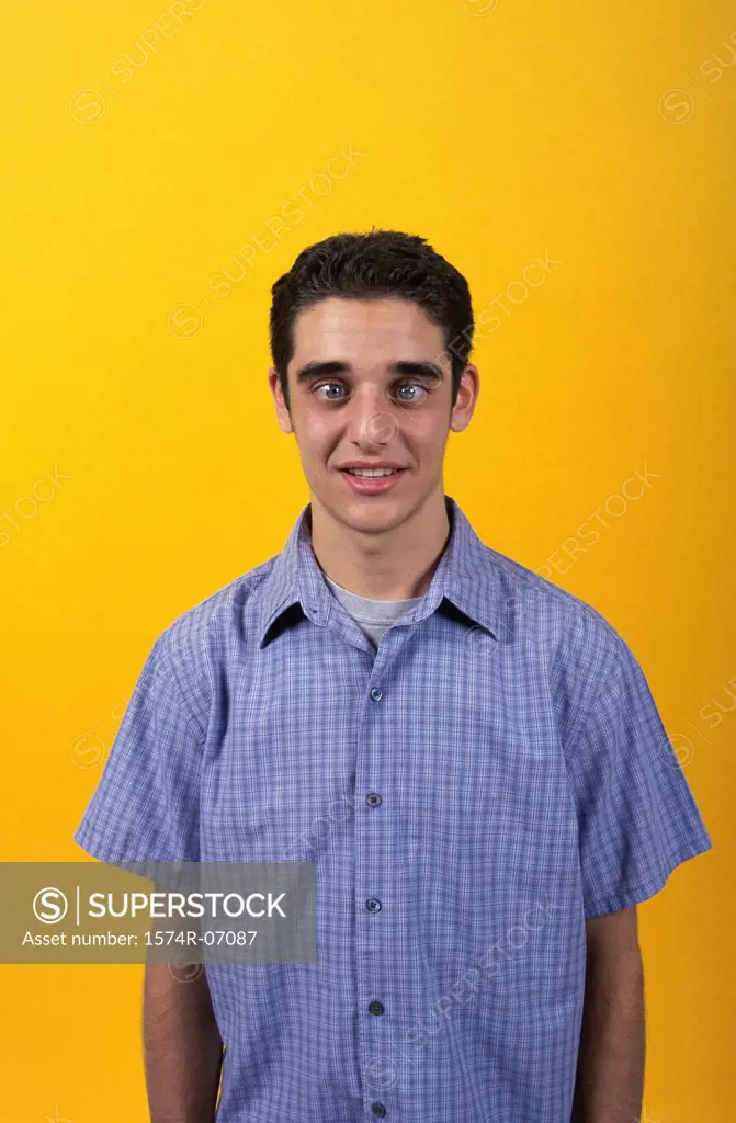 Portrait of a teenage boy making a face