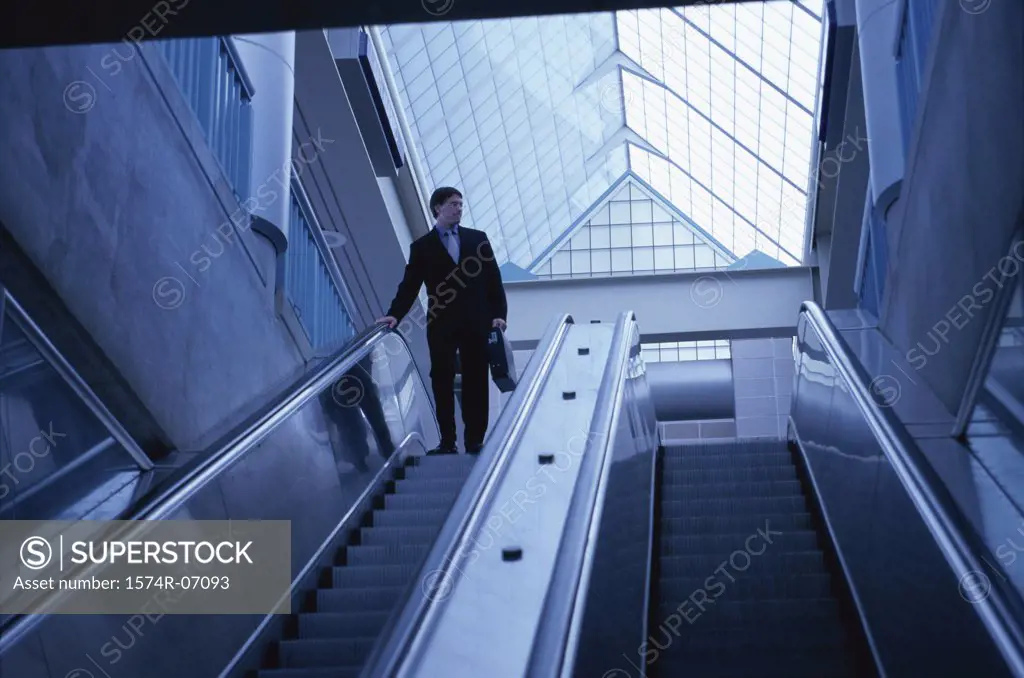 Low angle view of a businessman on an escalator