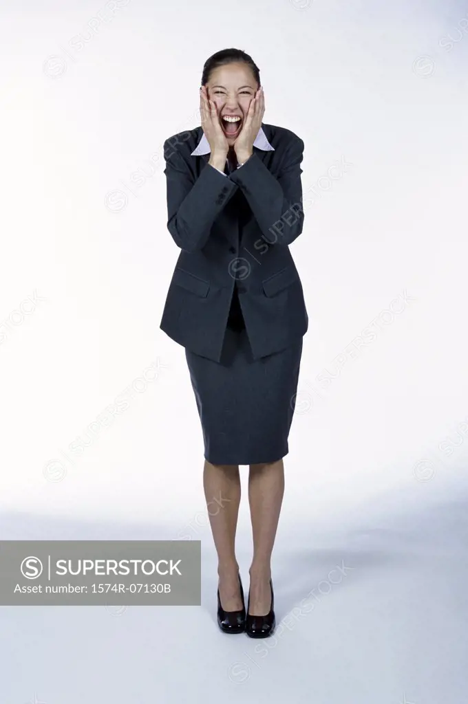 Portrait of a businesswoman holding her face laughing