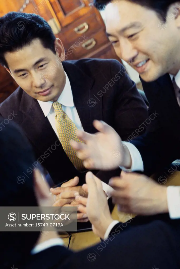 Three businessmen discussing