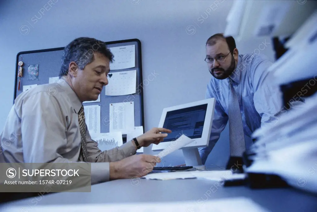 Low angle view of two businessmen discussing in an office