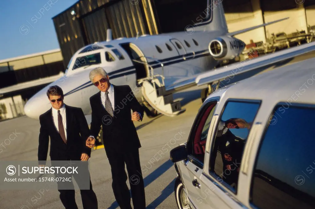 Two businessmen walking in an airport