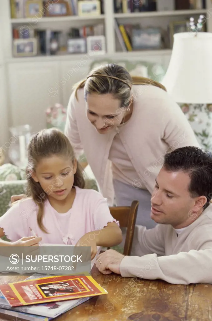 Parents helping their daughter study