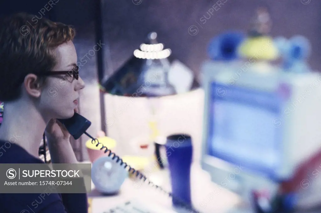 Side profile of a businesswoman talking on a telephone