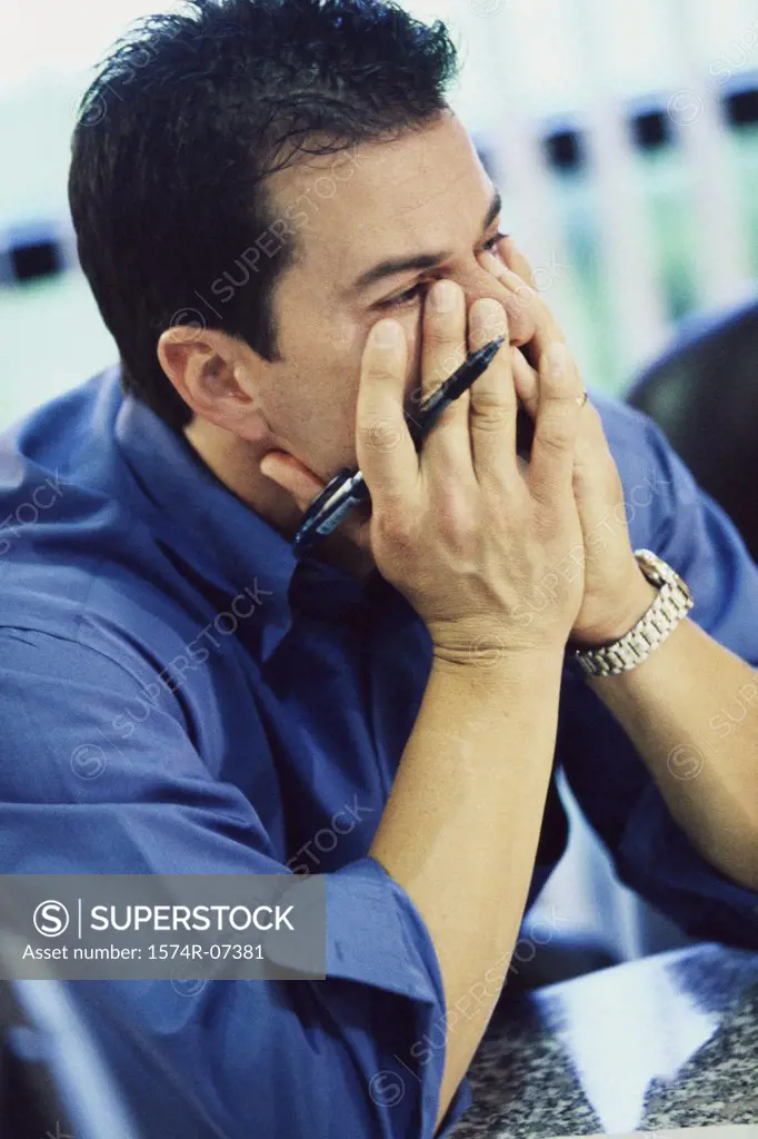 Businessman covering his mouth with his hands