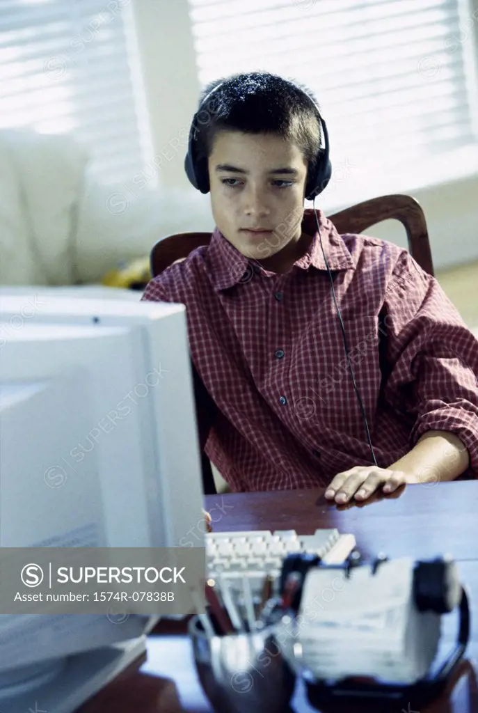 Teenage boy sitting in front of a computer monitor