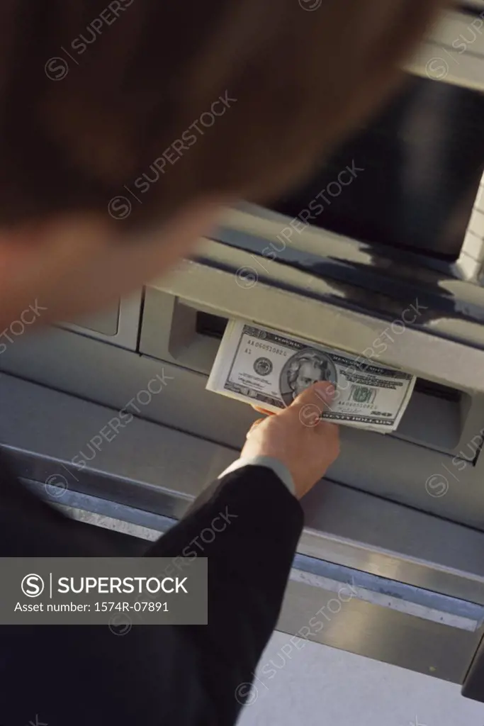 Person withdrawing cash from an ATM