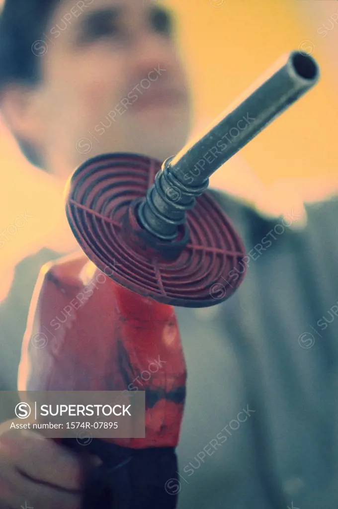 Gas station attendant holding a gas pump nozzle