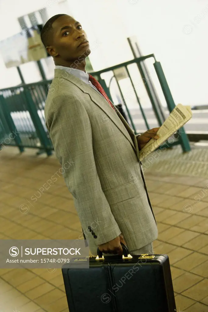 Young man standing with a briefcase