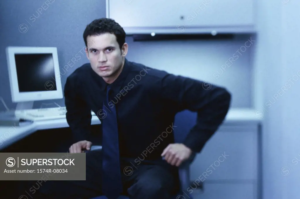 Portrait of a businessman seated at an office desk
