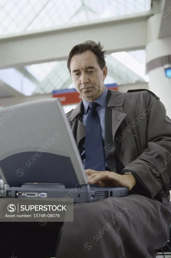Low angle view of businessman working on a laptop