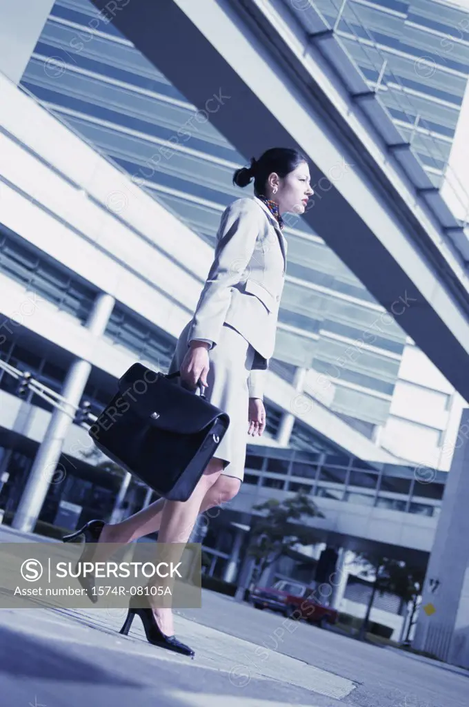 Low angle view of a businesswoman walking with a briefcase