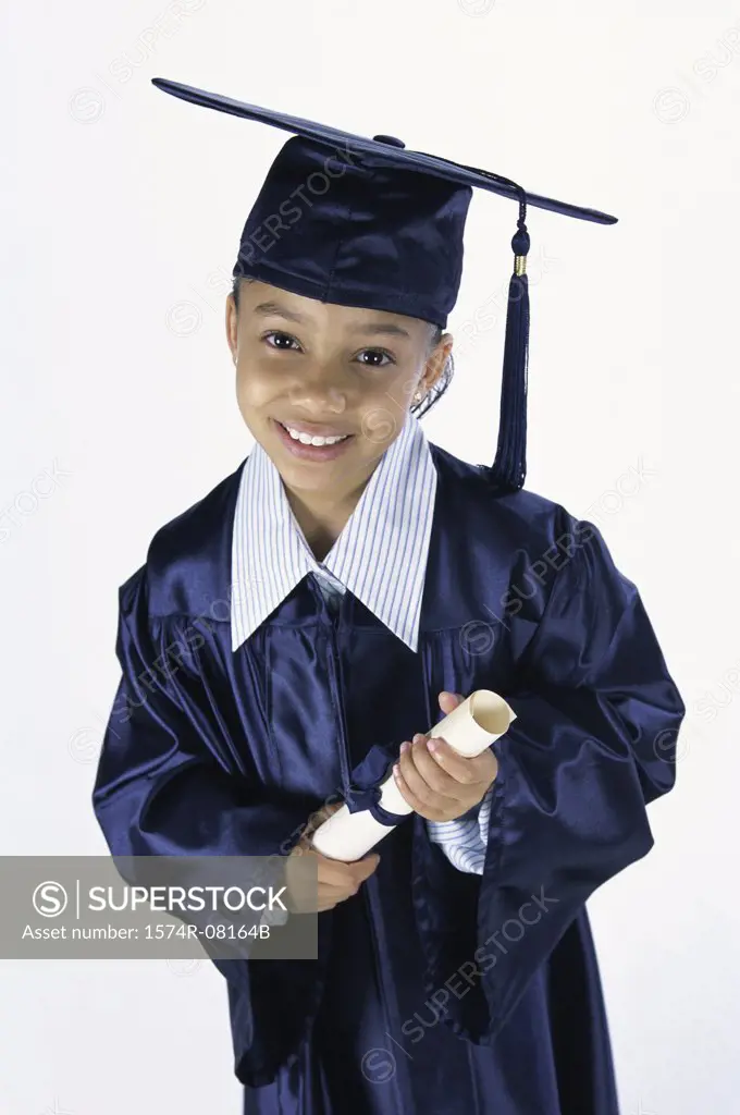 Portrait of a girl dressed in a graduation outfit holding a diploma