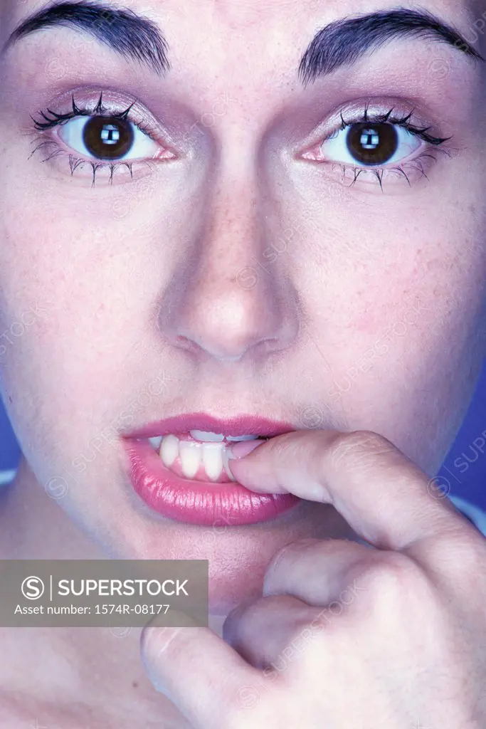 Portrait of a young woman with her finger in her mouth