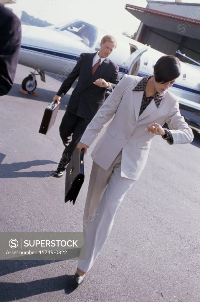 Businessman and a businesswoman walking at the airport