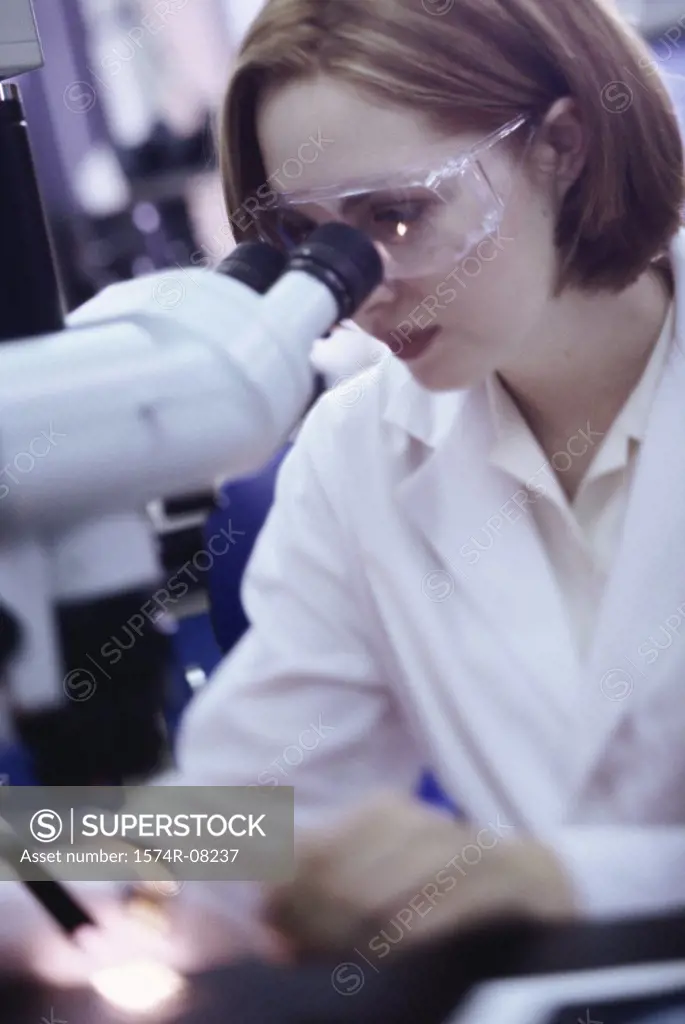 Female researcher working with a microscope