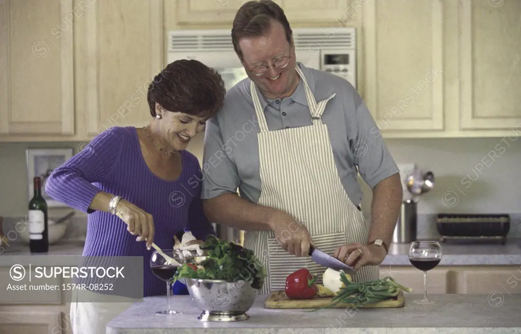 Couple chopping vegetables in a kitchen