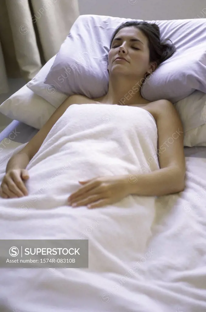 Young woman sleeping in a bed