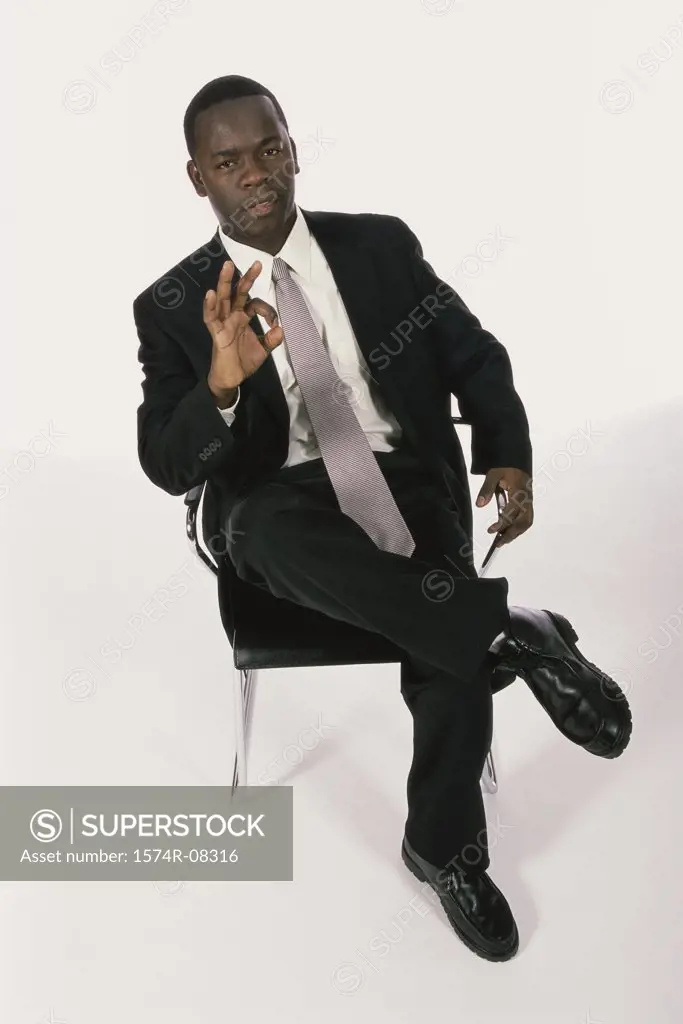 High angle view of a businessman making an OK sign