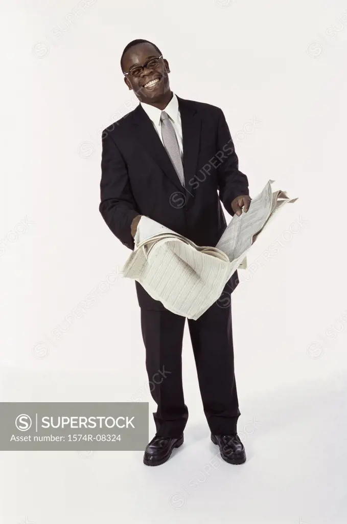 Portrait of a businessman holding a newspaper smiling