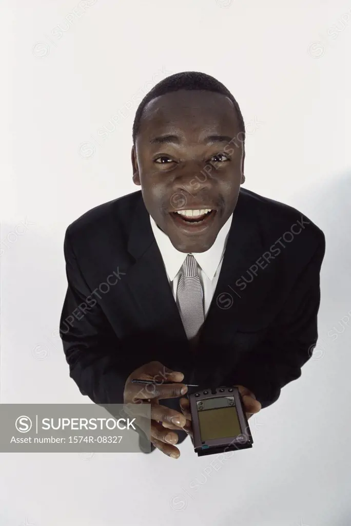 Portrait of a businessman holding a hand held device