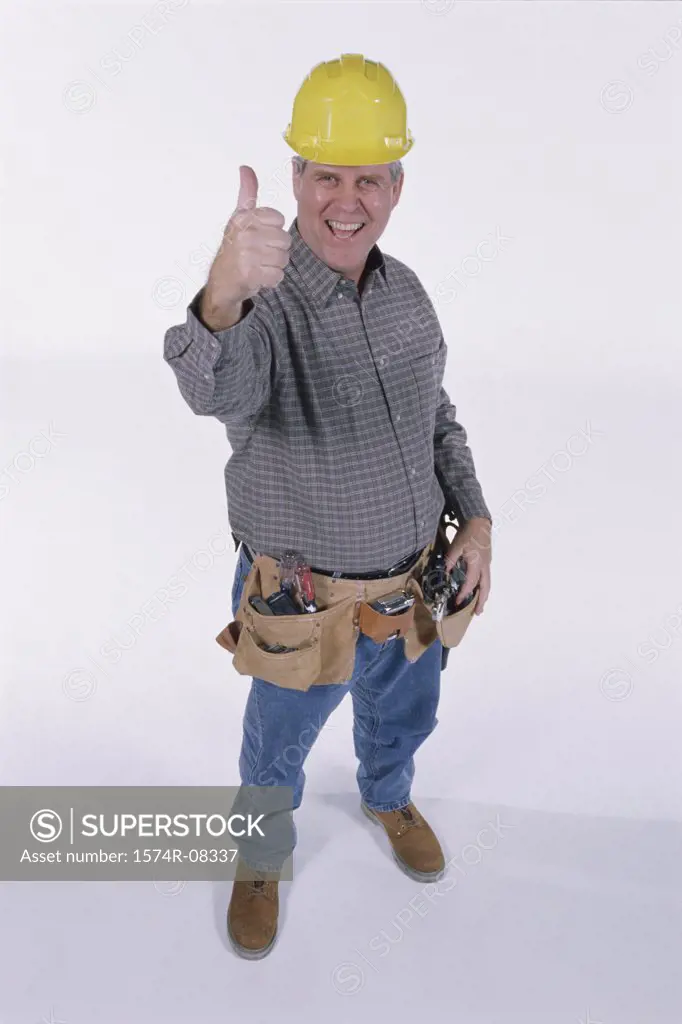 Portrait of a construction worker showing thumbs up sign