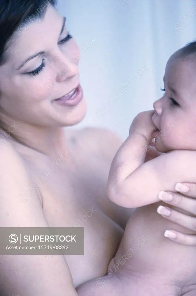 Close-up of a mother holding her baby boy in her arms
