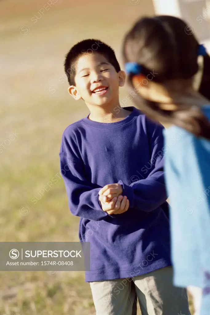 Girl and a boy playing on a lawn