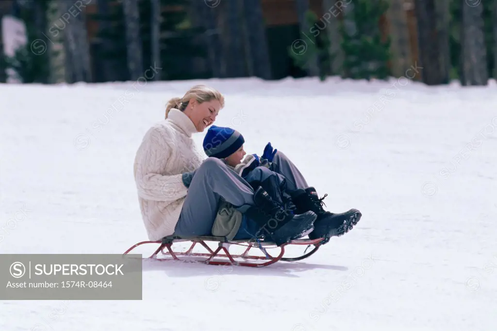 Mother and son together on a sled