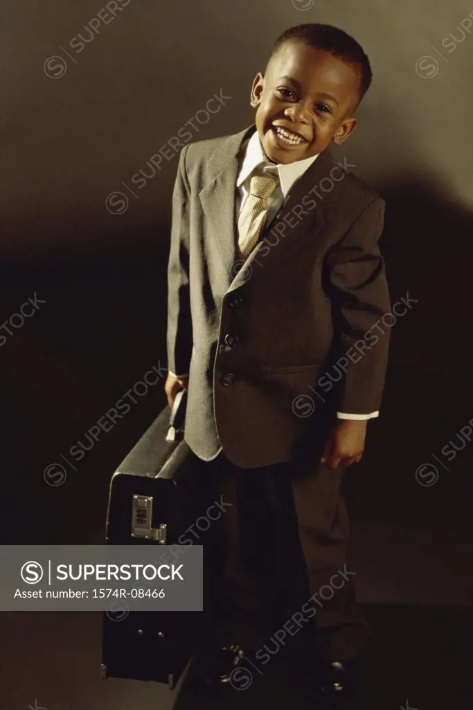 Portrait of a young boy dressed as a businessman smiling