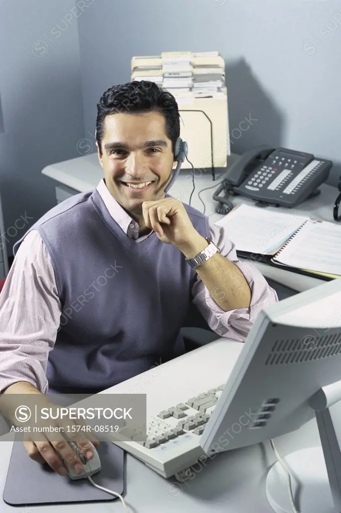 Portrait of a customer service representative working on a computer
