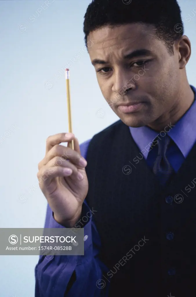 Businessman holding a pencil