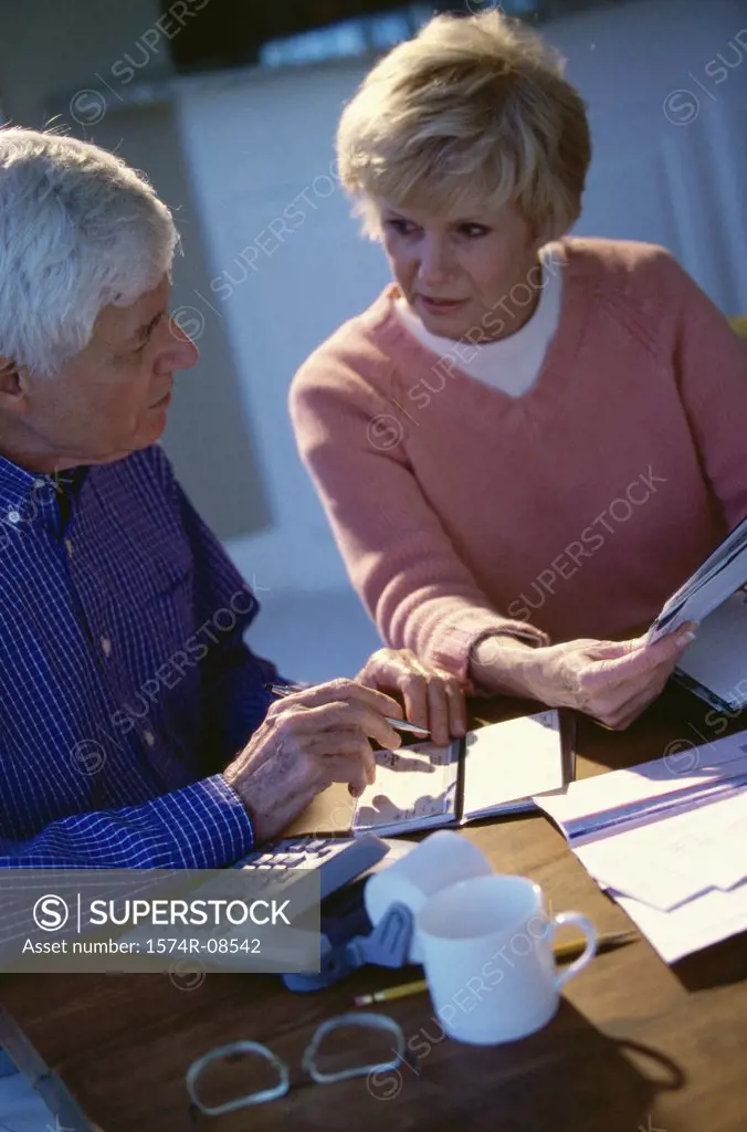 Senior couple writing a check
