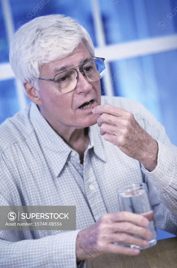 Senior man taking a pill