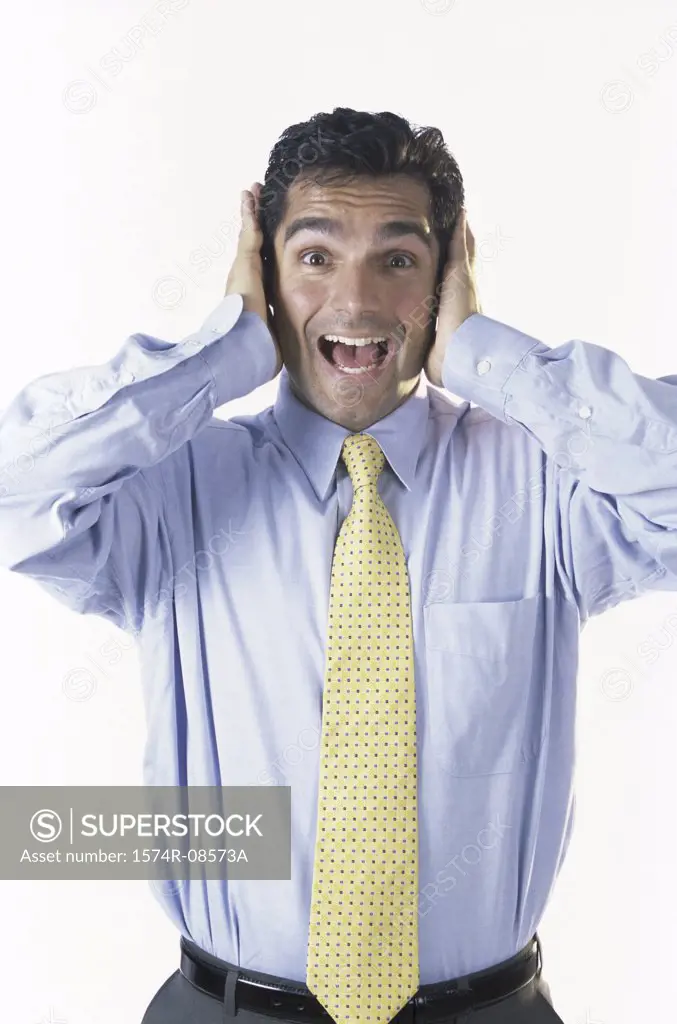 Portrait of a businessman with his hands covering his ears