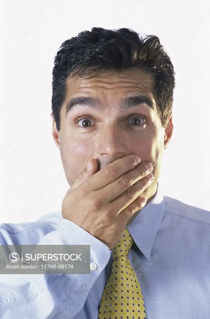 Portrait of a businessman with his hand covering his mouth