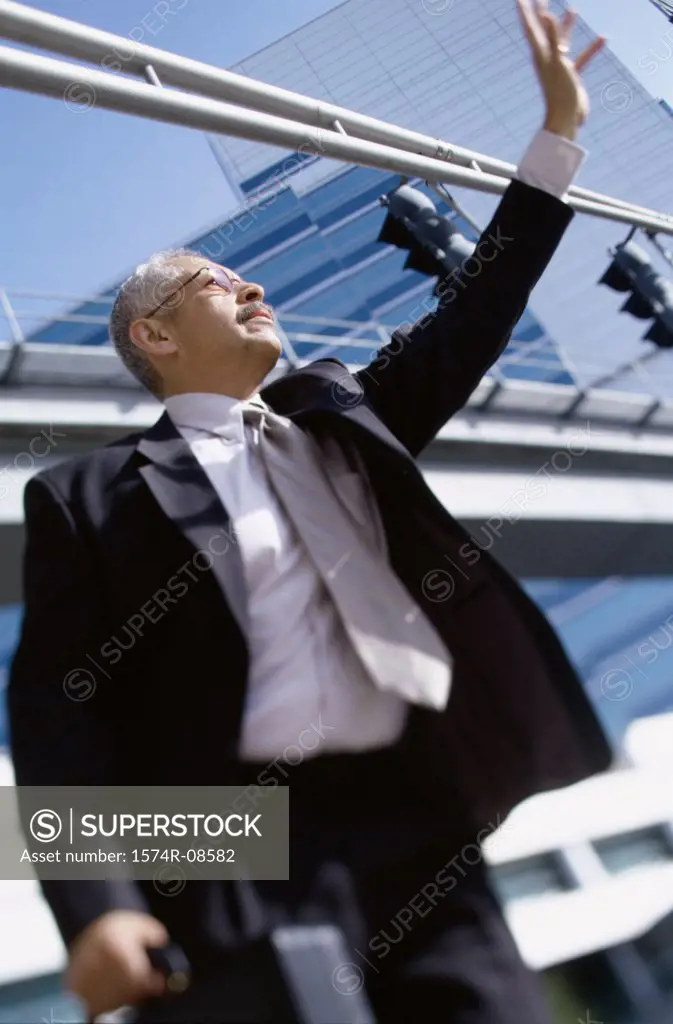 Low angle view of a businessman waving