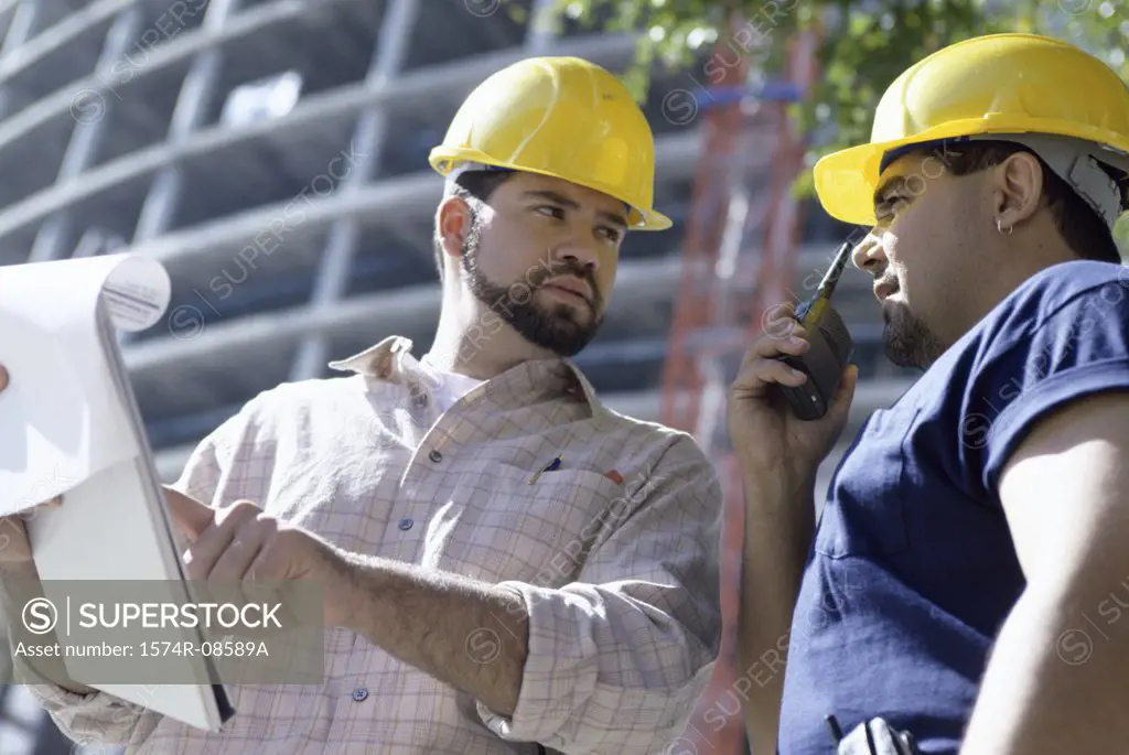 Low angle view of two foremen working at a construction site