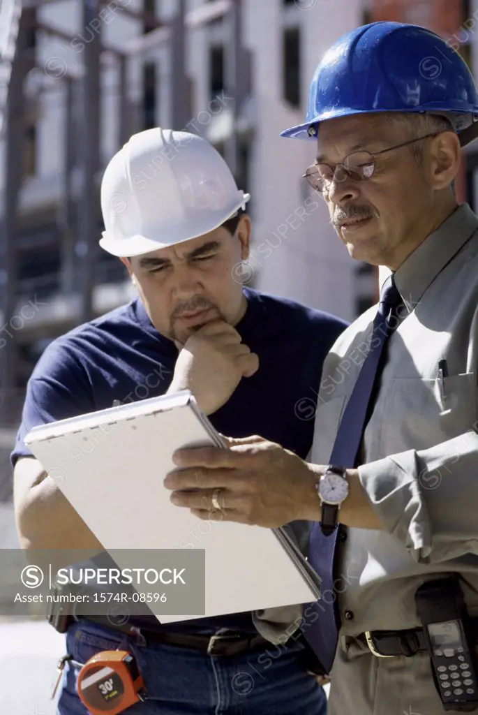 Two foremen discussing at a construction site