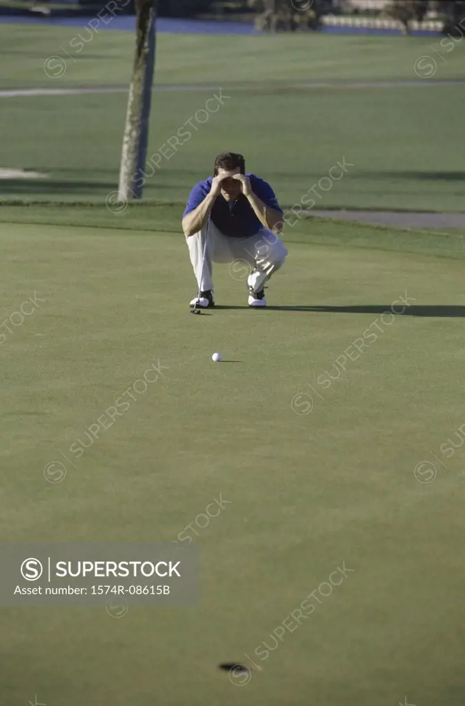 Man looking at a golf ball