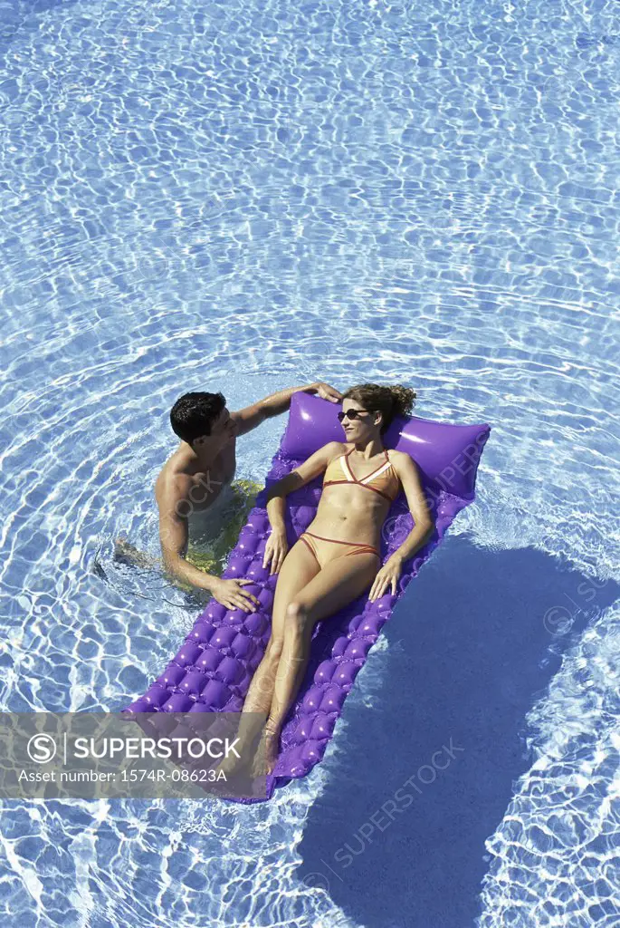 High angle view of a young couple together in a swimming pool