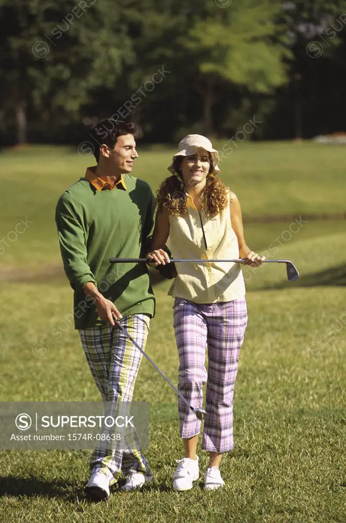 Mid adult man and a mid adult woman on a golf course