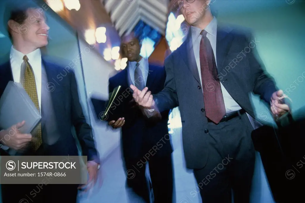 Group of businessmen walking in a corridor