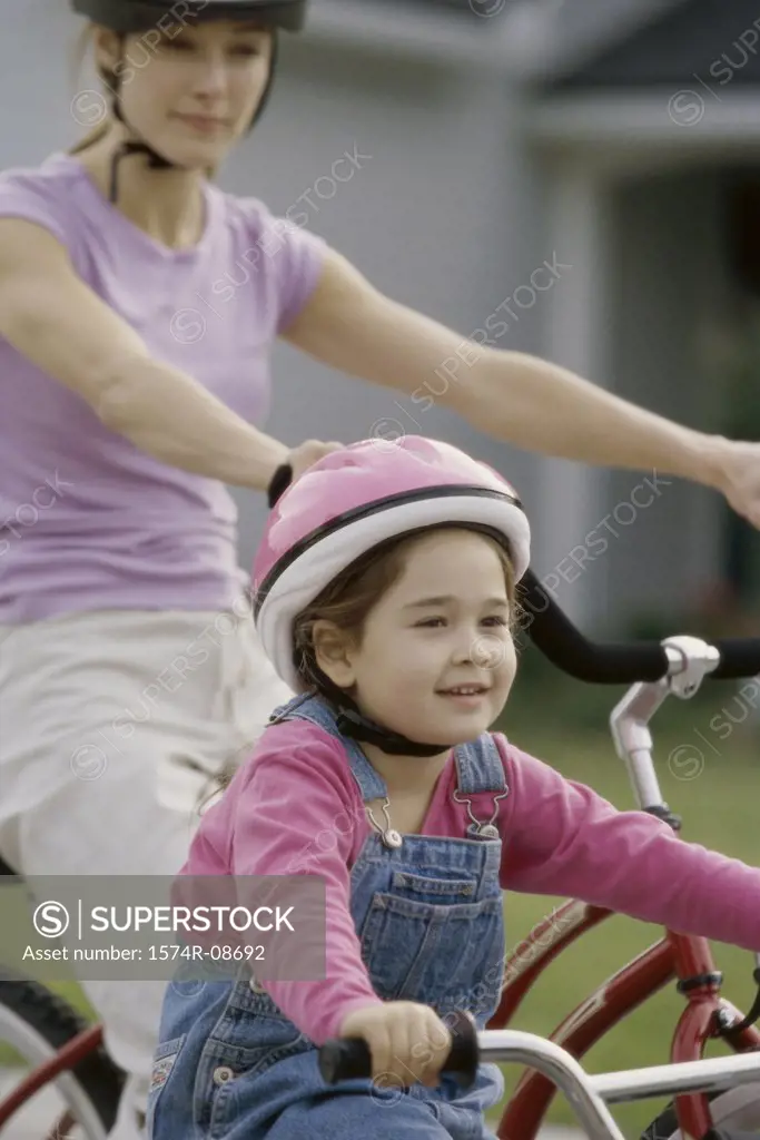 Mother and daughter riding bicycles
