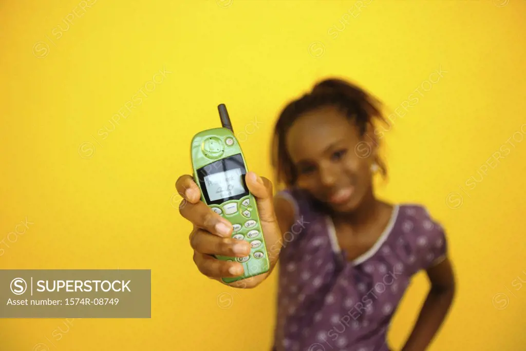 Portrait of a teenage girl holding a mobile phone