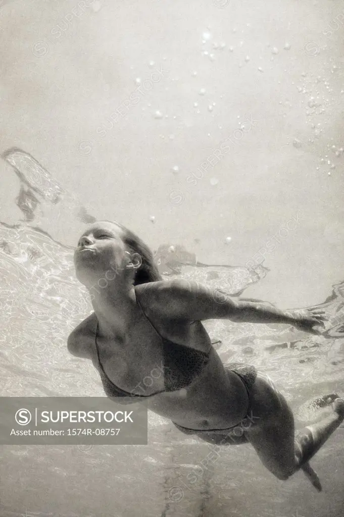 Young woman swimming in a swimming pool