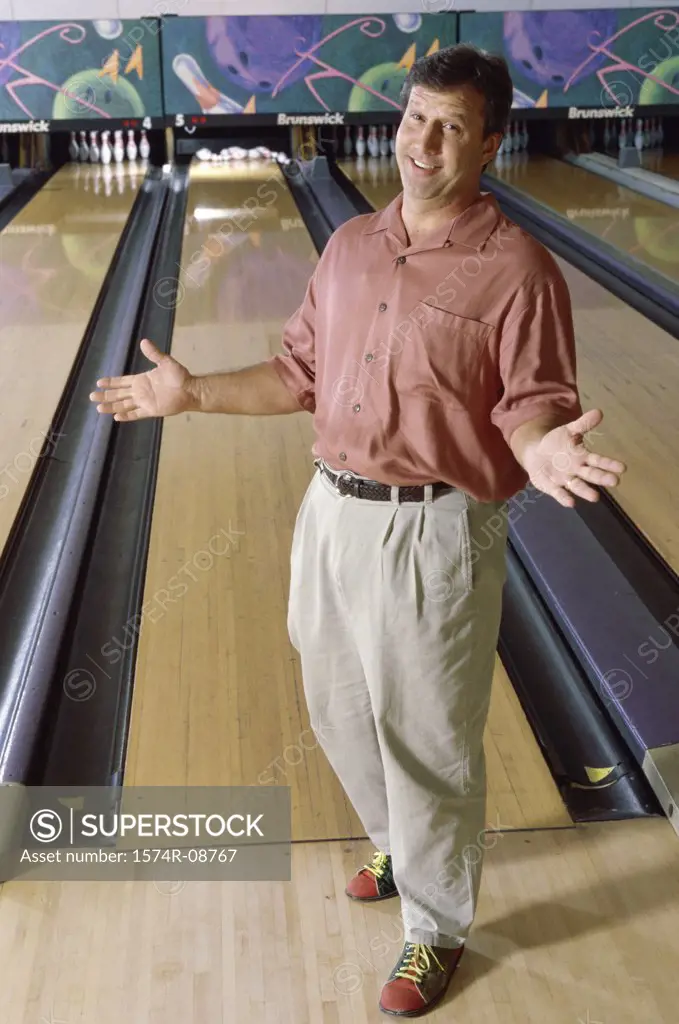 Portrait of a mid adult man in a bowling alley