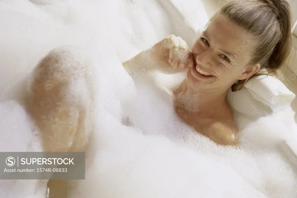 Portrait of a young woman in a bubble bath