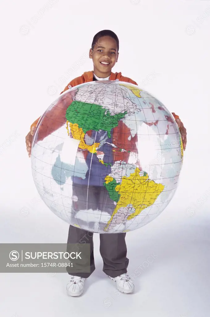 Portrait of a boy holding an inflatable globe